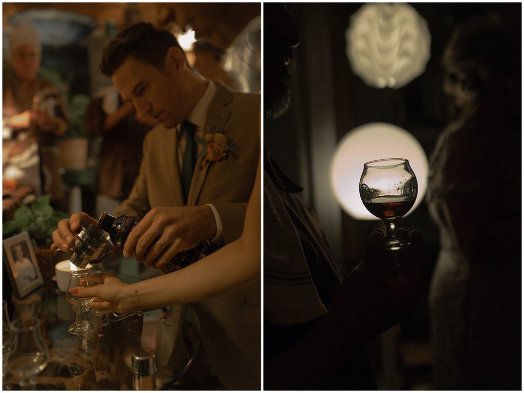 A wedding guest holds a glass in front of a round light.