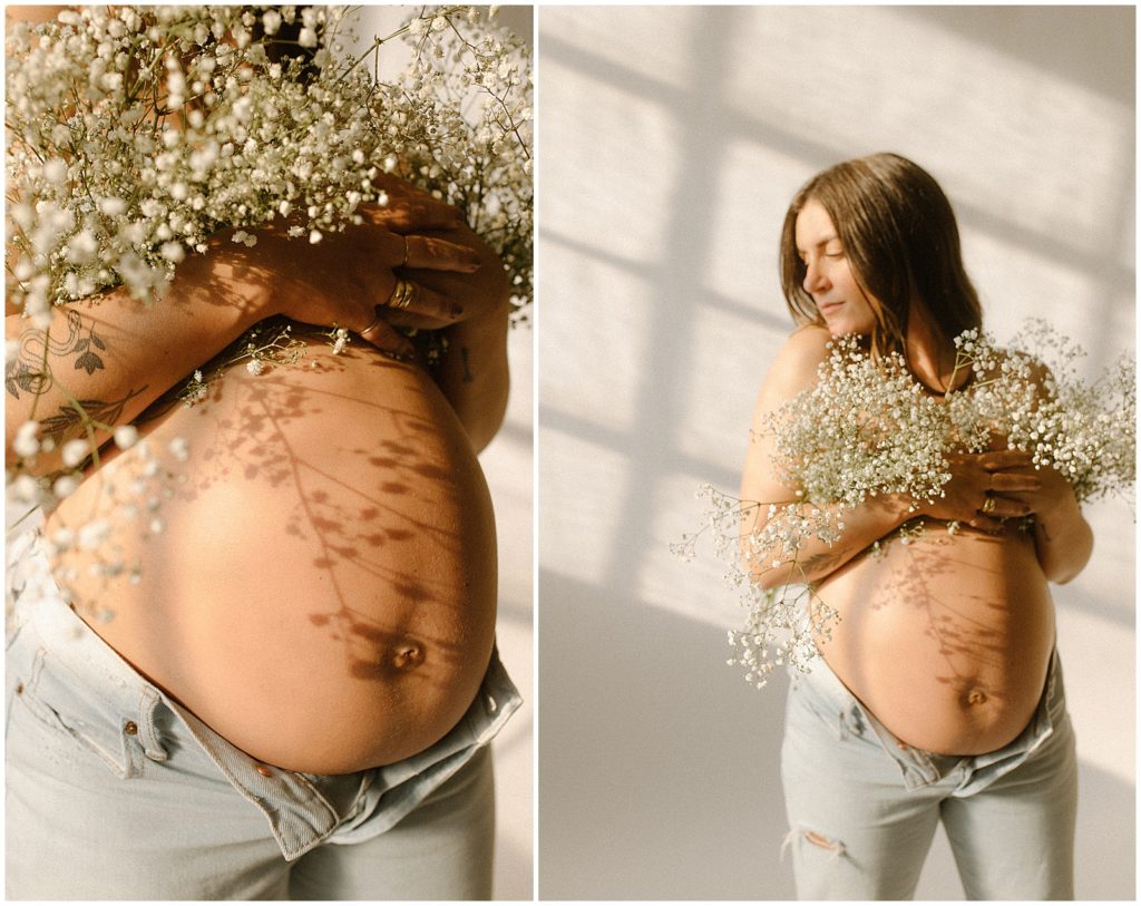 Nicole holds bundles of baby's breath flowers to her chest.