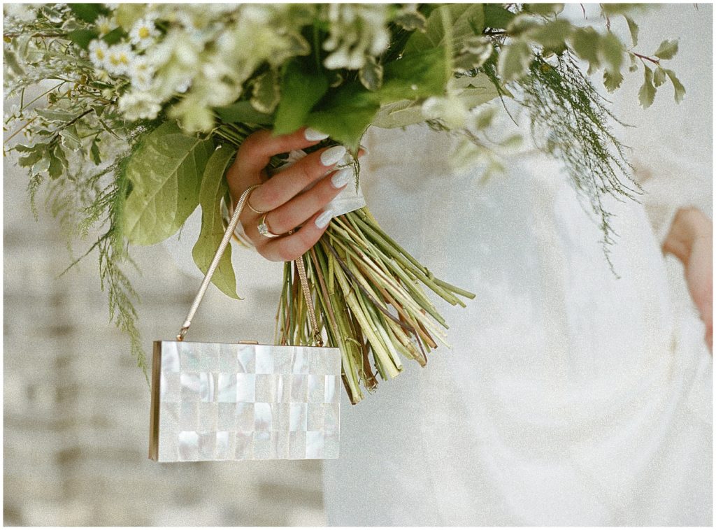 Sarah carries a vintage wedding purse with her wedding bouquet.