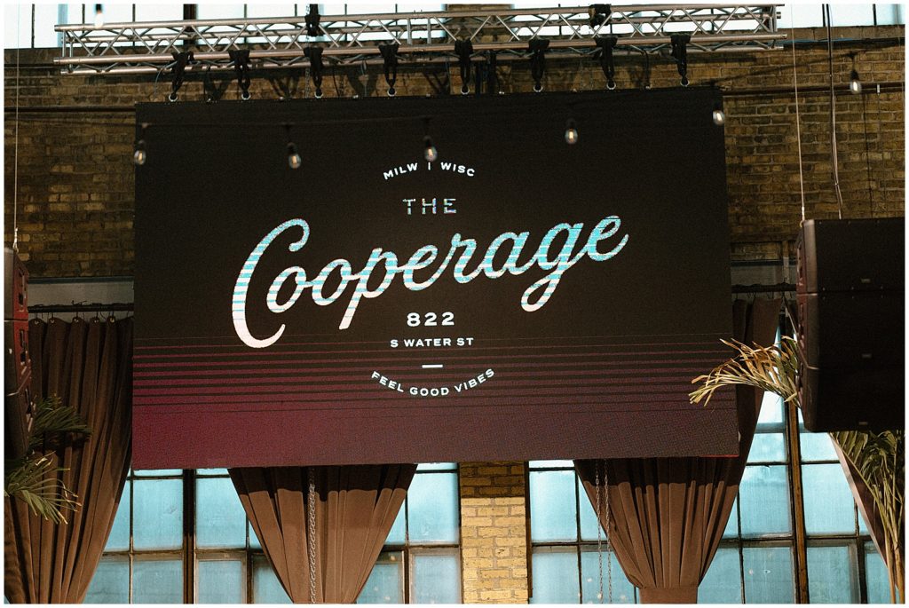 A red awning has The Cooperage logo inside the Milwaukee wedding venue.