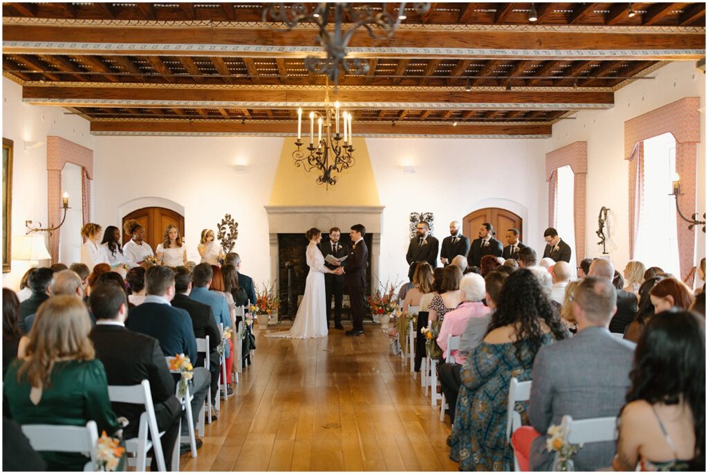 Guests sit to watch an indoor wedding ceremony at Villa Terrace Milwaukee.