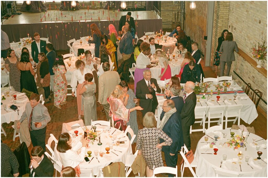 An overhead view of wedding guests gathering in a Milwaukee reception venue.