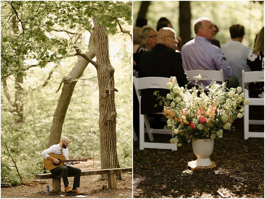 A musician sits on a bench under a tree playing a guitar for a wedding processional.