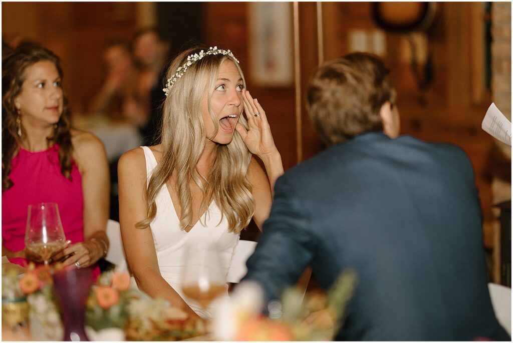 A bride's jaw drops in reaction to a wedding toast.