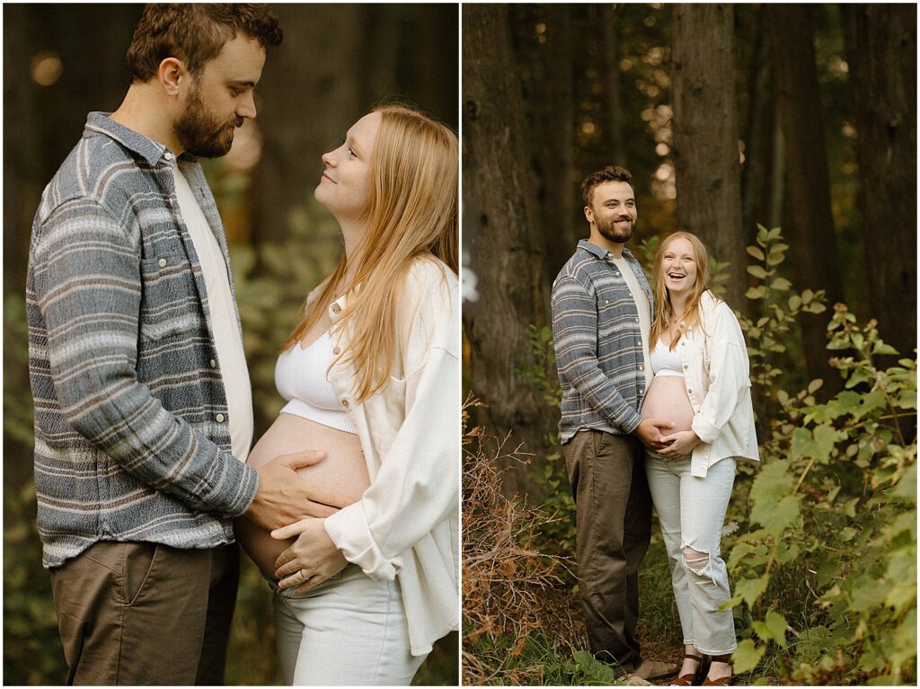 A couple poses at the edge of the woods for Door County maternity photos.