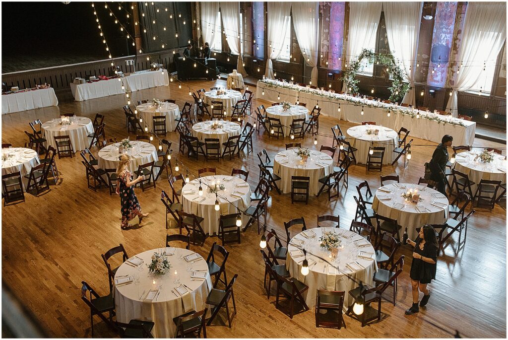 Round tables are decorated for the reception at a Turner Hall wedding.