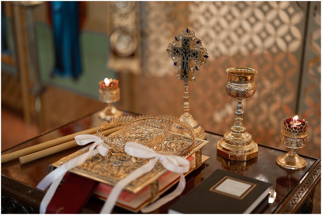 Candles and a Bible sit on a table before a Greek Orthodox wedding.