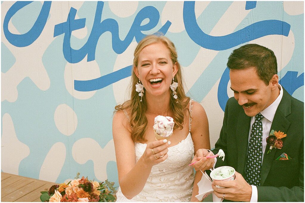 A bride and groom laugh over ice cream in film wedding photography in Milwuakee.