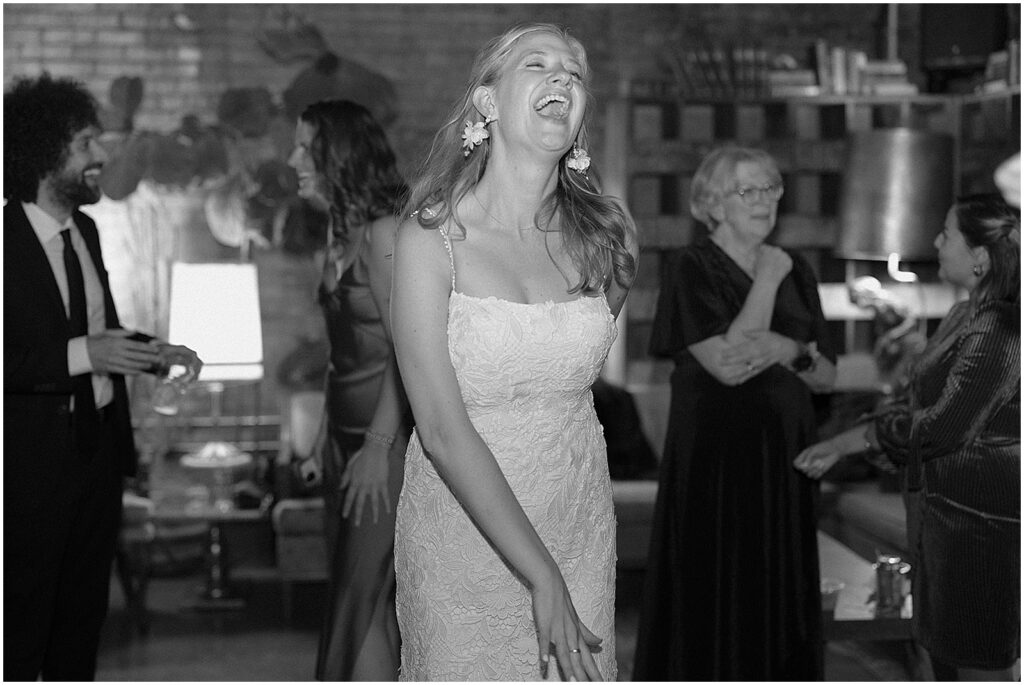 A bride sings along to a song while she dances.