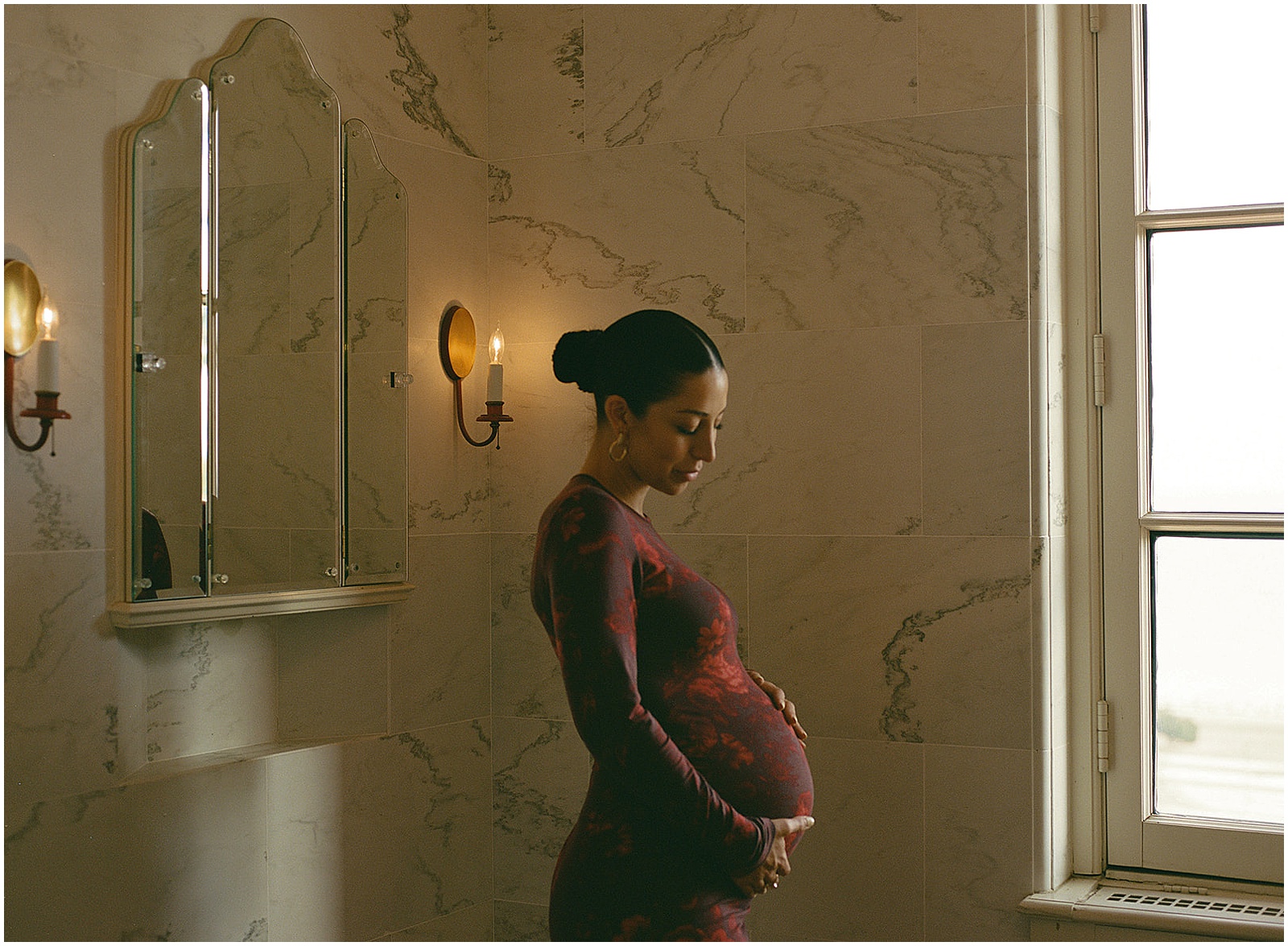 A woman in a chic dress poses for maternity photography on film inside Villa Terrace Milwaukee.