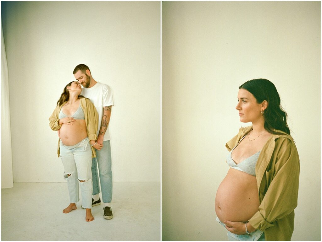 A pregnant woman leans against her husband in a maternity photo on film photographhy.