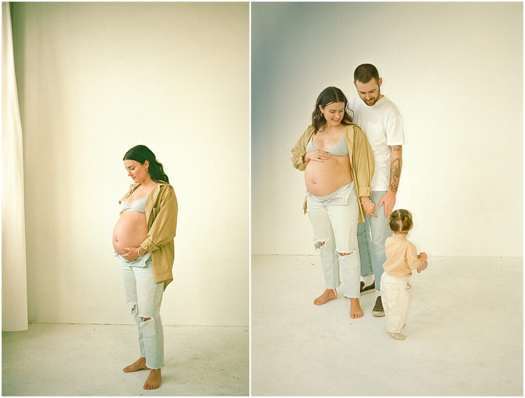 A toddler walks towards her mother and father in a Milwaukee photography studio in film photography.