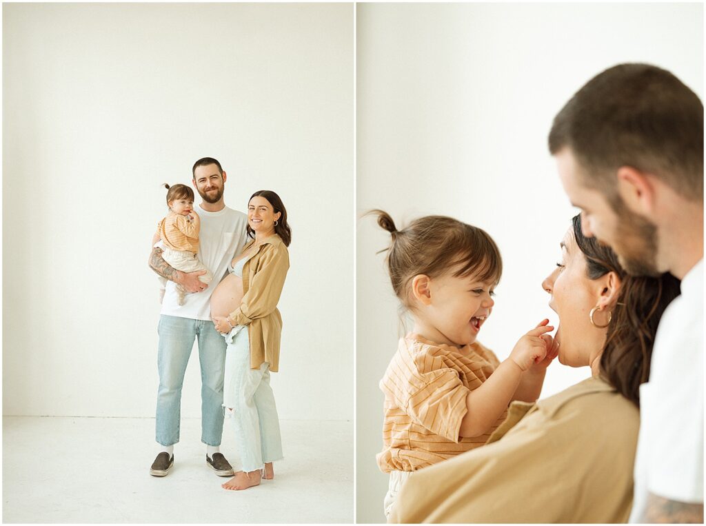 A man and woman interact with their smiling toddler while a Milwaukee family photographer takes their picture from behind.