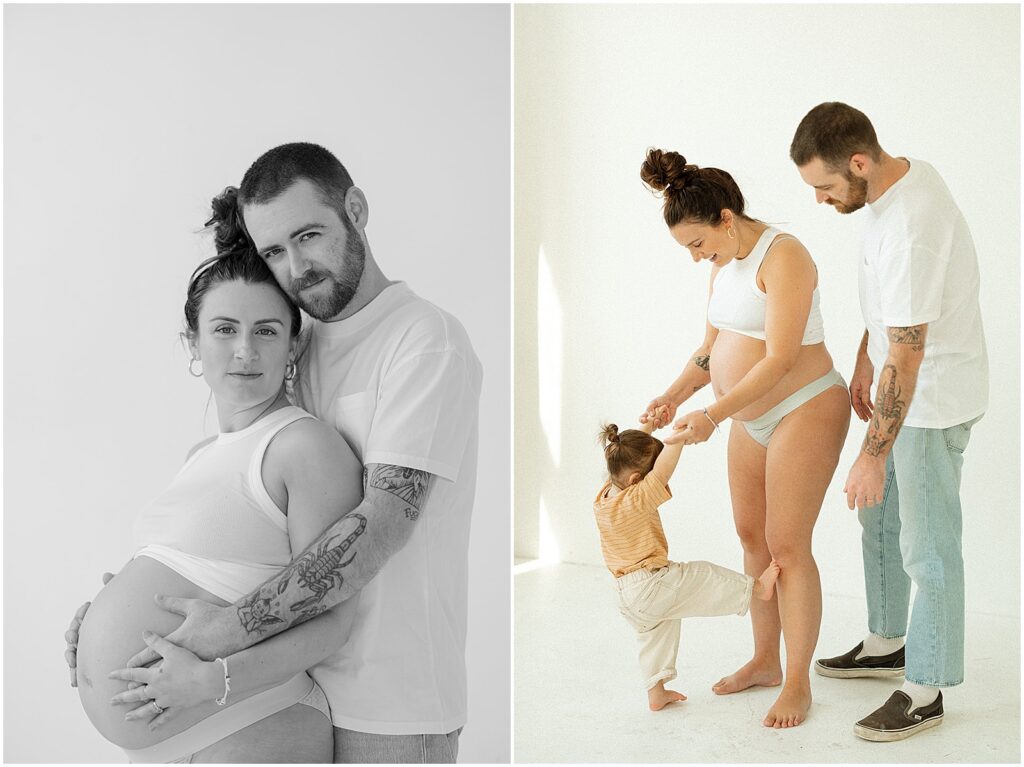 A man puts his arm around his pregnant wife while they look at a Milwaukee family photographer.