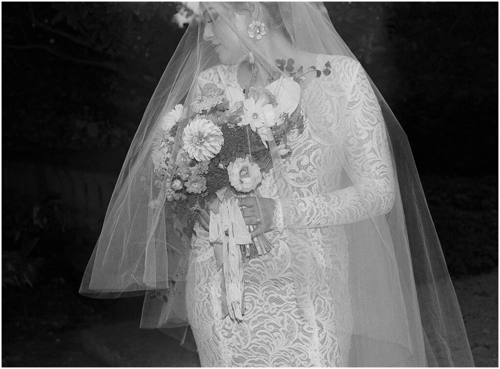 A bride looks over her shoulder in an editorial film wedding photo.
