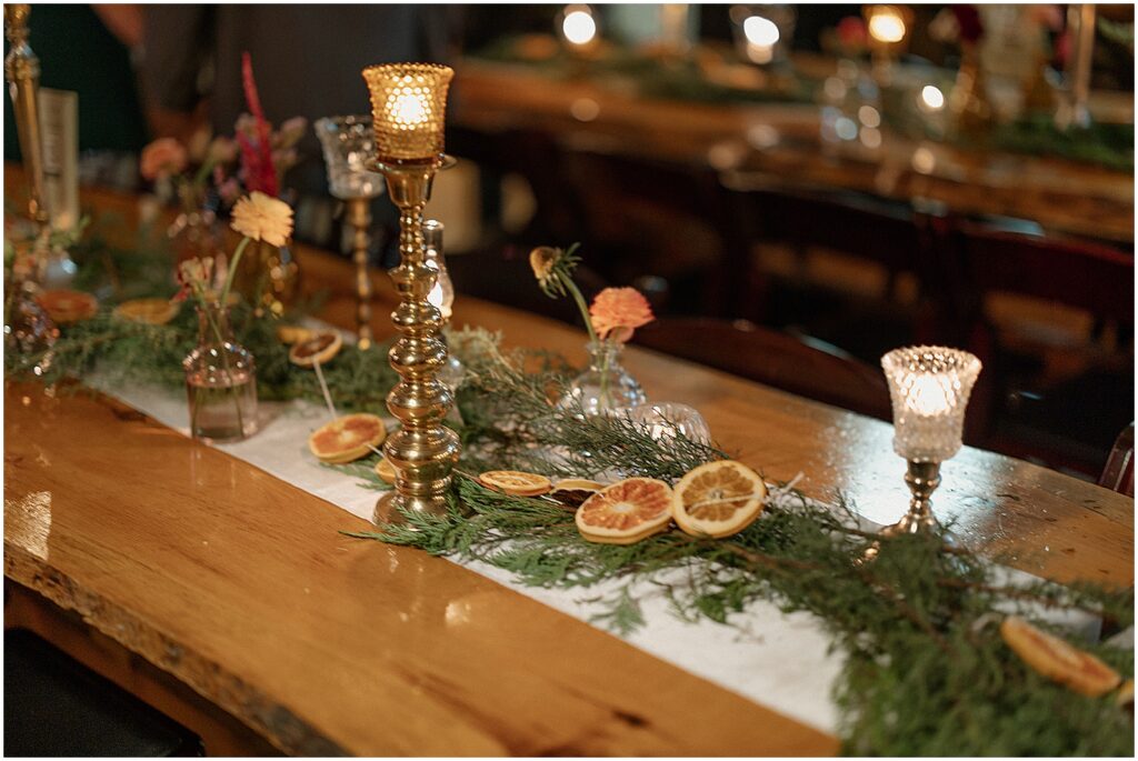 Dried oranges and ferns decorate a table for a winter wedding at Anodyne Coffee.