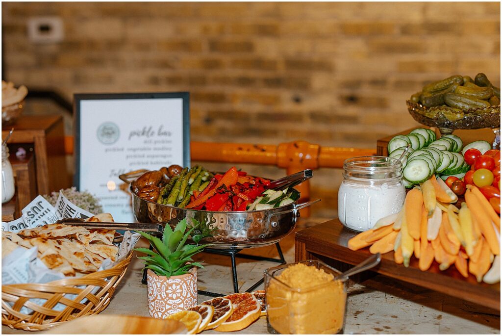 A buffet table is decorated with candles and plants.