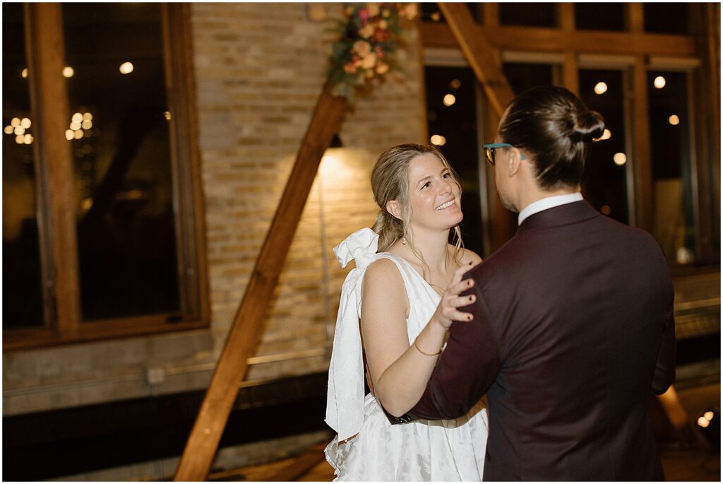 A bride and groom share their first dance in their Milwaukee wedding venue.