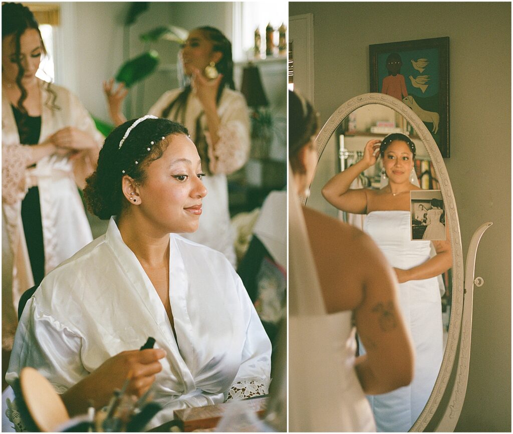 A bride pats her hair while she looks in a mirror in film wedding photography.