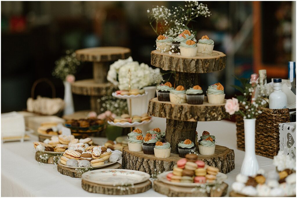 Cupcakes and cookies sit on a dessert table at a Milwaukee wedding reception.