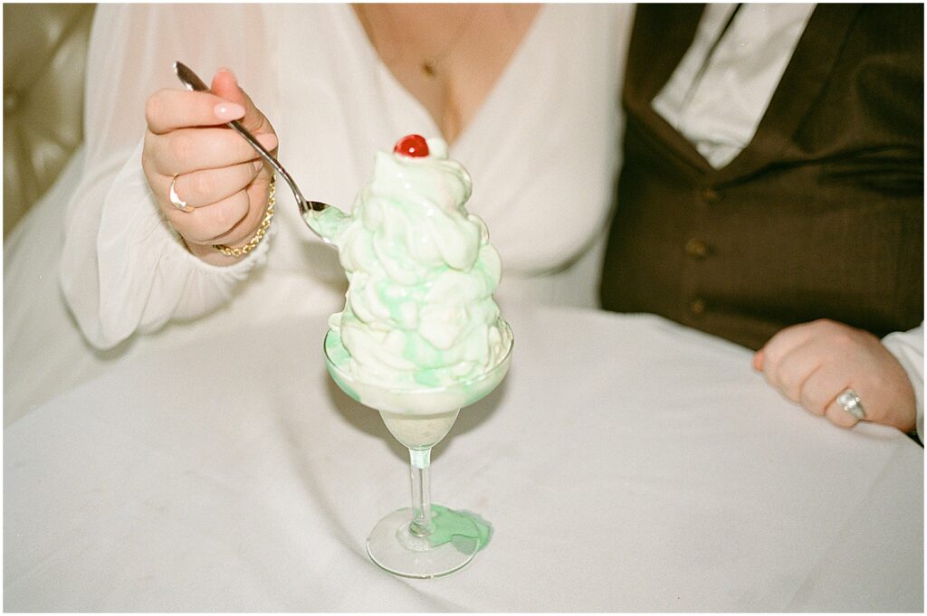 A bride takes a spoonful of grasshopper at the Hobnob Restaurant.