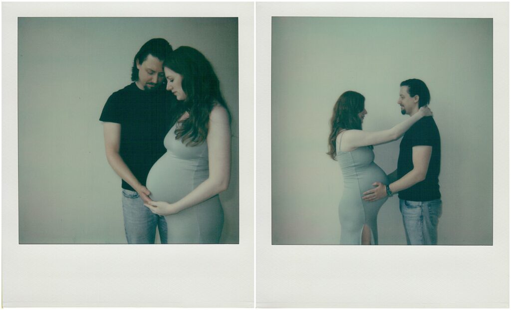 A man and woman stand with their arms around each other in maternity photography on Polaroid film.