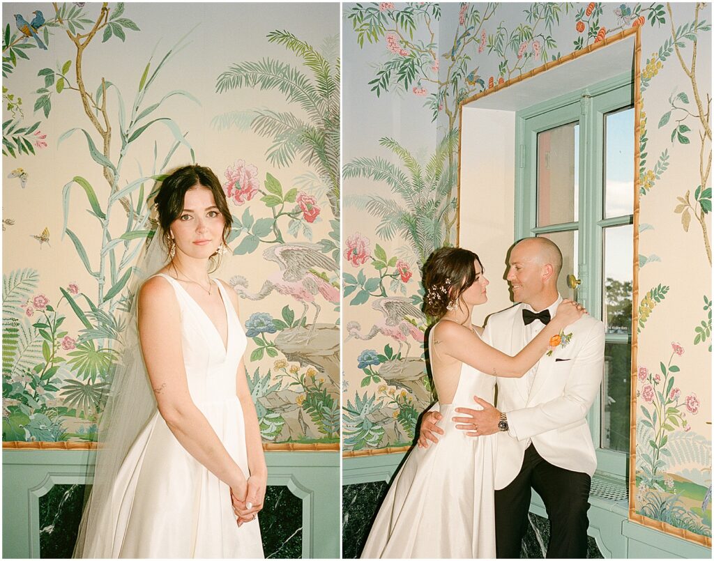 A bride and groom pose in a room with floral wallpaper at their Villa Terrace Milwaukee wedding.