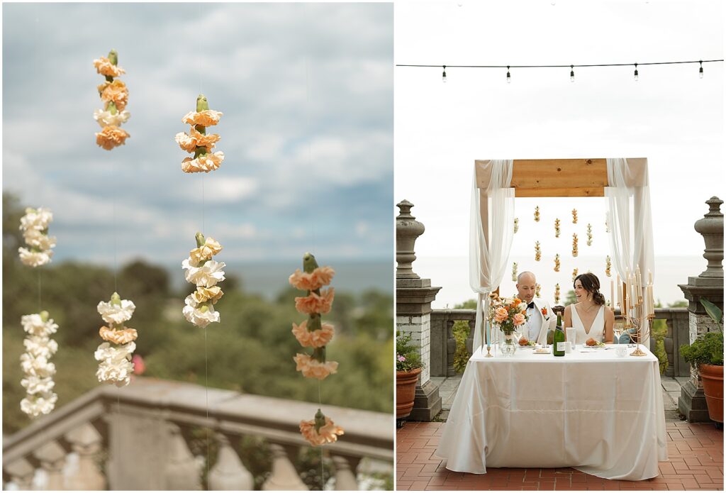 A floral installation hangs behind a sweetheart table at an art museum wedding in Milwaukee.