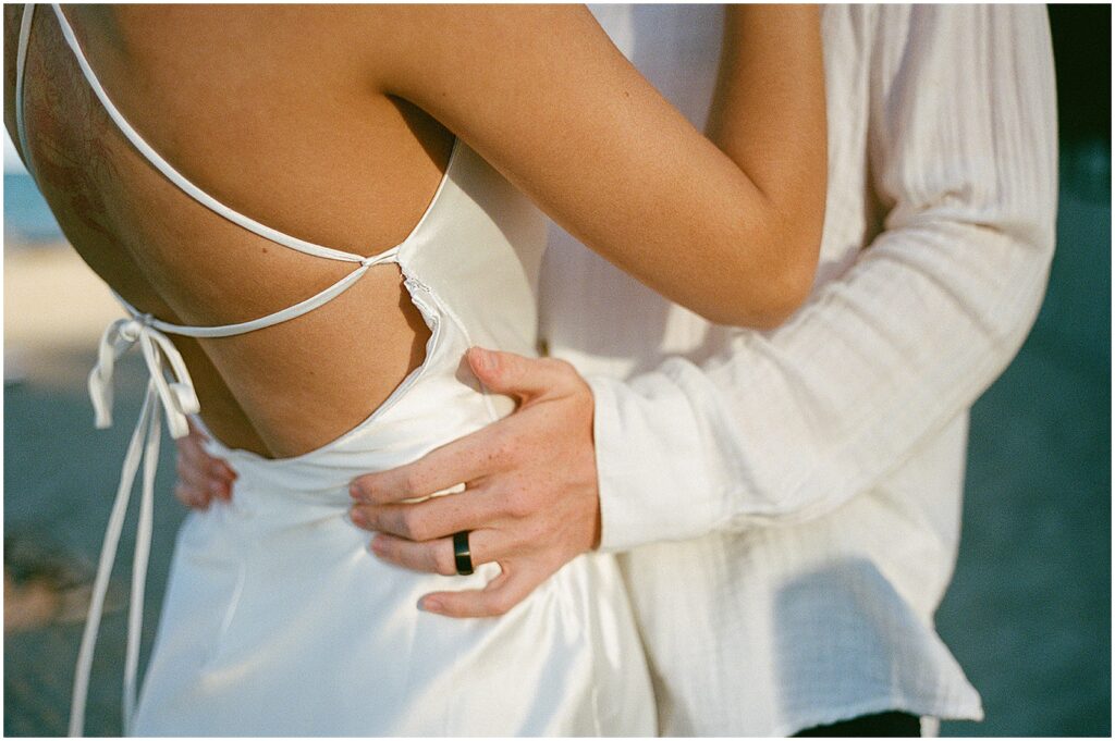 A groom puts his hands on a bride's waist during their Milwaukee elopement.