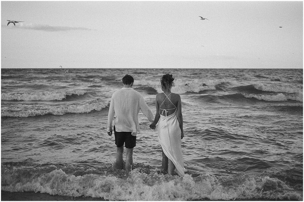 A bride and groom wade into Lake Michigan after their Milwaukee elopement.