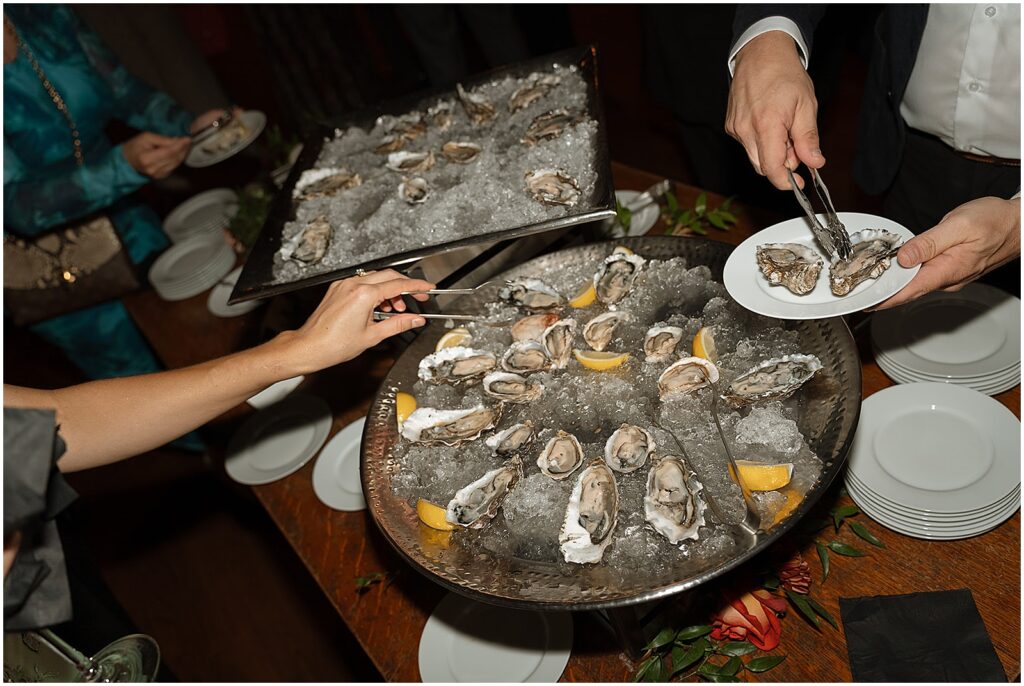 Wedding guests serve themselves oysters.