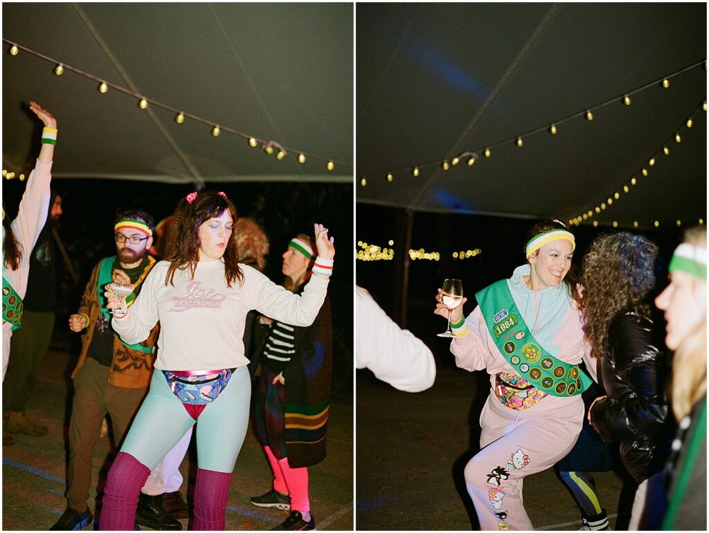 People in costumes dance in a tent.