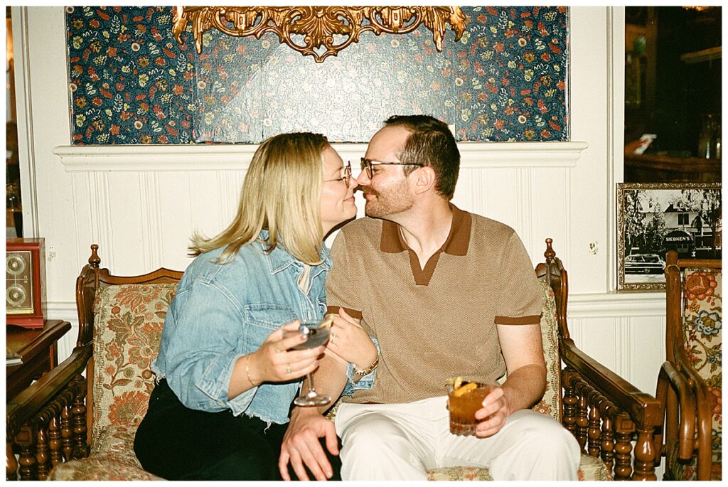 a couple cuddling on a vintage sofa
